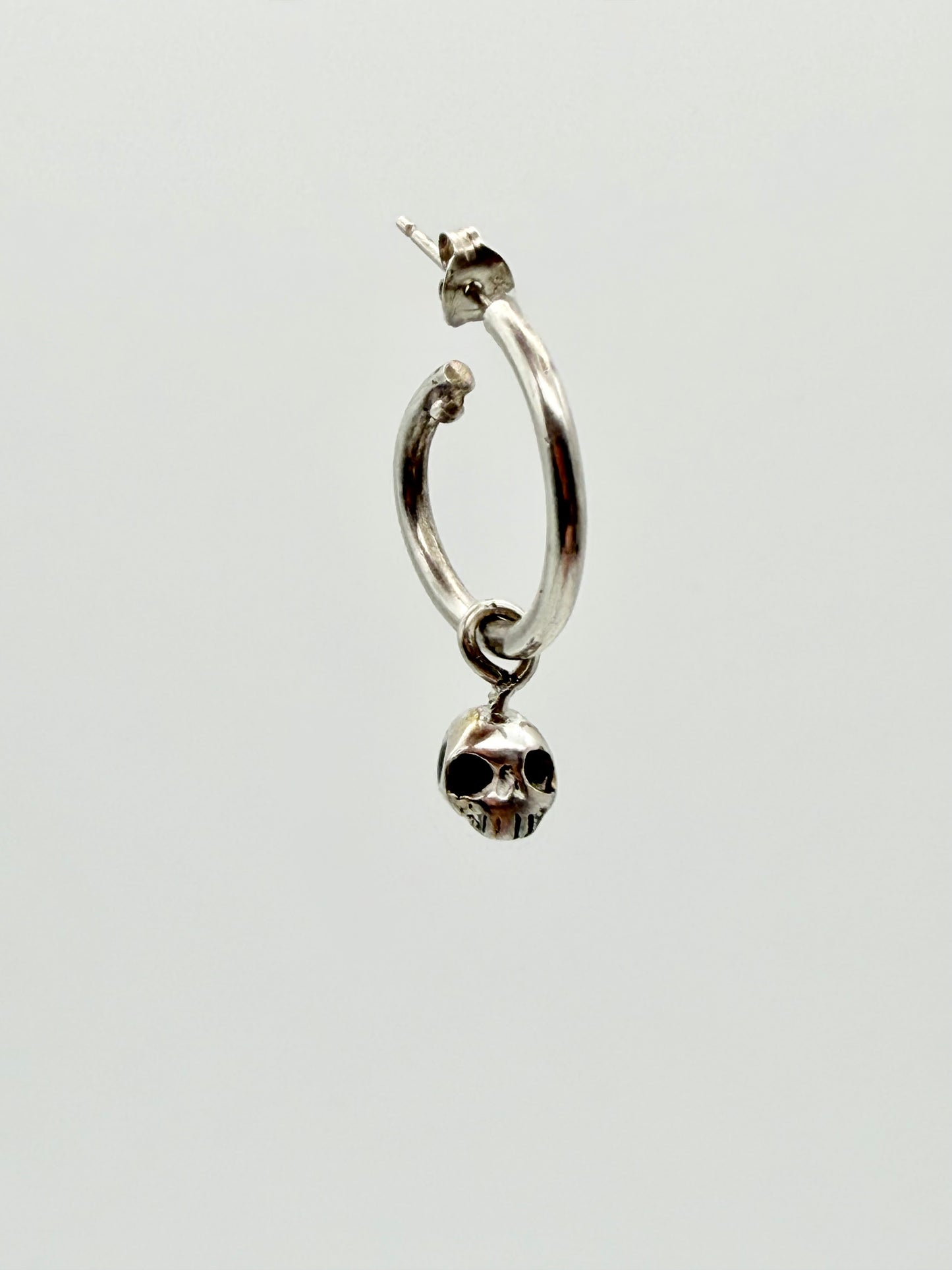 Skull charm hoop earrings — handmade gold and silver by Virginia Allan