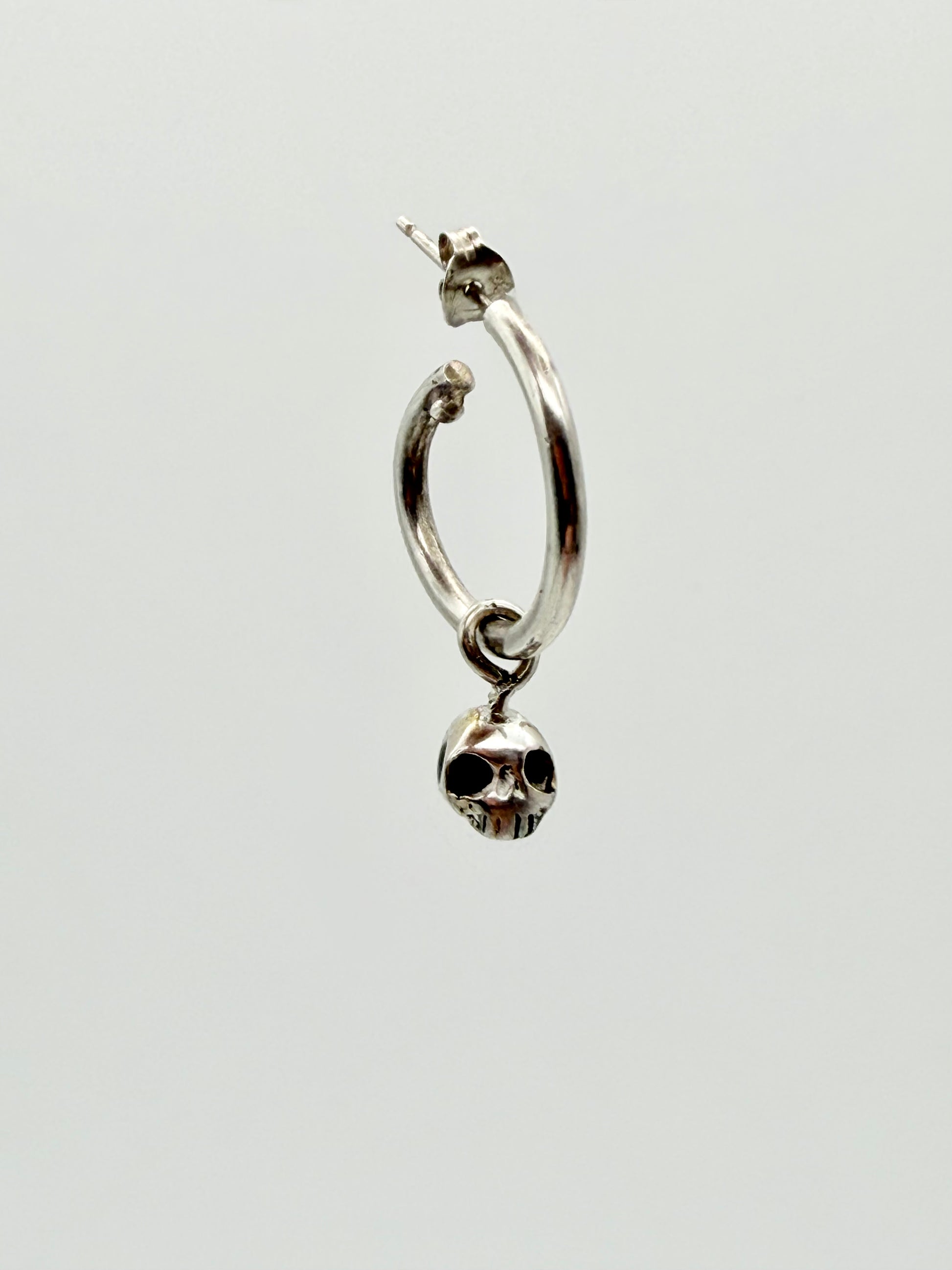 Skull charm hoop earrings — handmade gold and silver by Virginia Allan