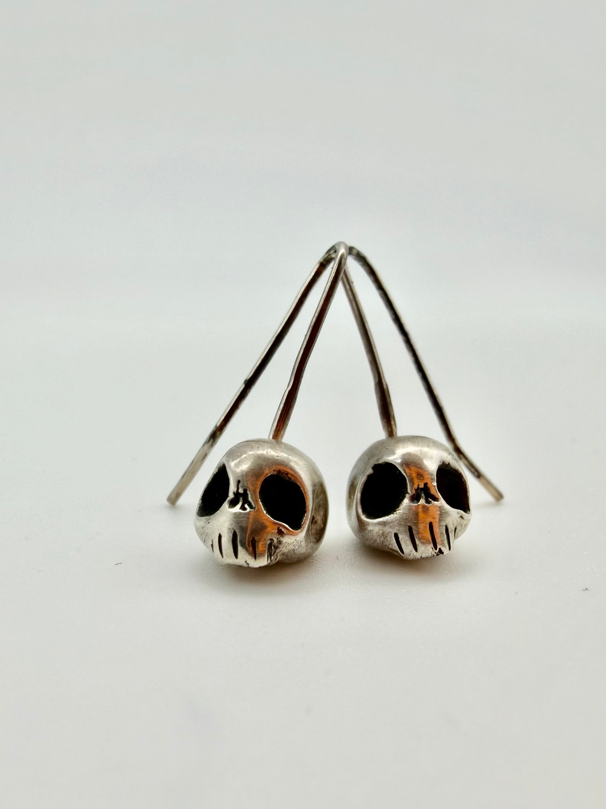 Silver skull drop earrings — handmade sterling silver by Virginia Allan