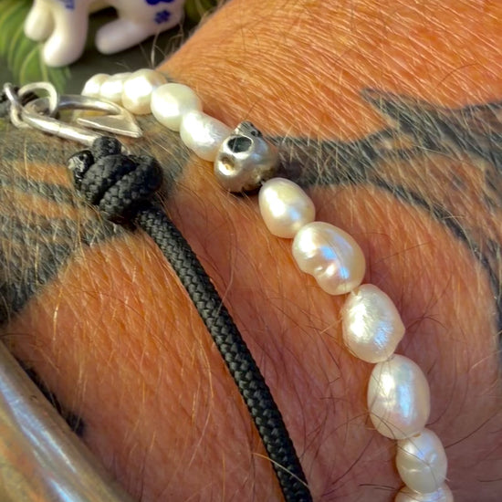 video of The skull and pearl bracelet worn on the wrist — handmade sterling silver and freshwater pearls