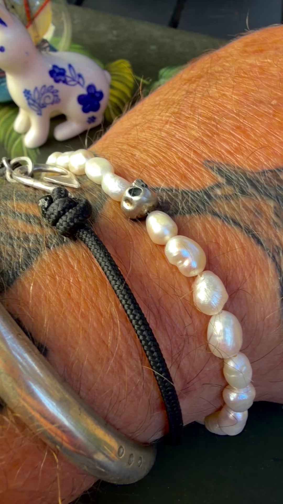 video of The skull and pearl bracelet worn on the wrist — handmade sterling silver and freshwater pearls