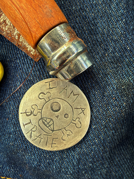 solid silver pirate badge